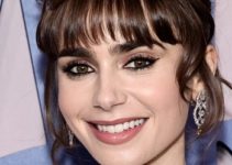 Lily Collins – Intricate Updo/Bangs (2022) – “Emily In Paris” French Consulate Red Carpet Event